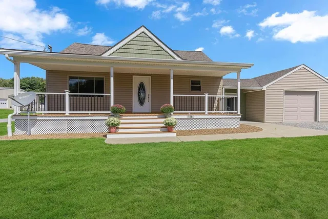 a front view of a house with a garden