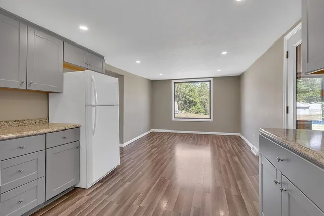 a view of kitchen with wooden floor electronic appliances and window