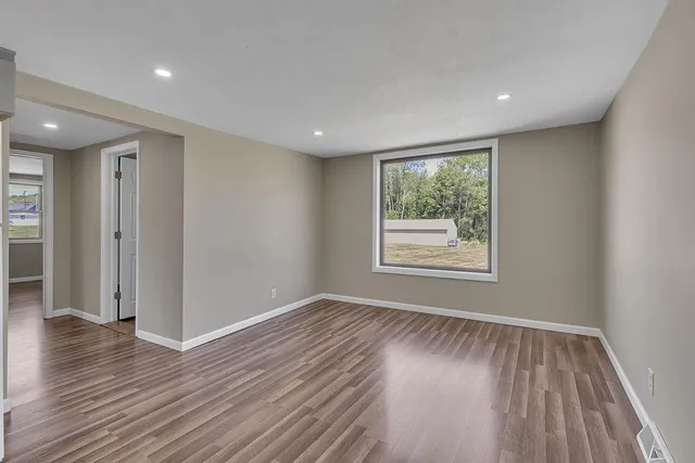 a view of a kitchen with a sink and dishwasher a refrigerator with wooden floor