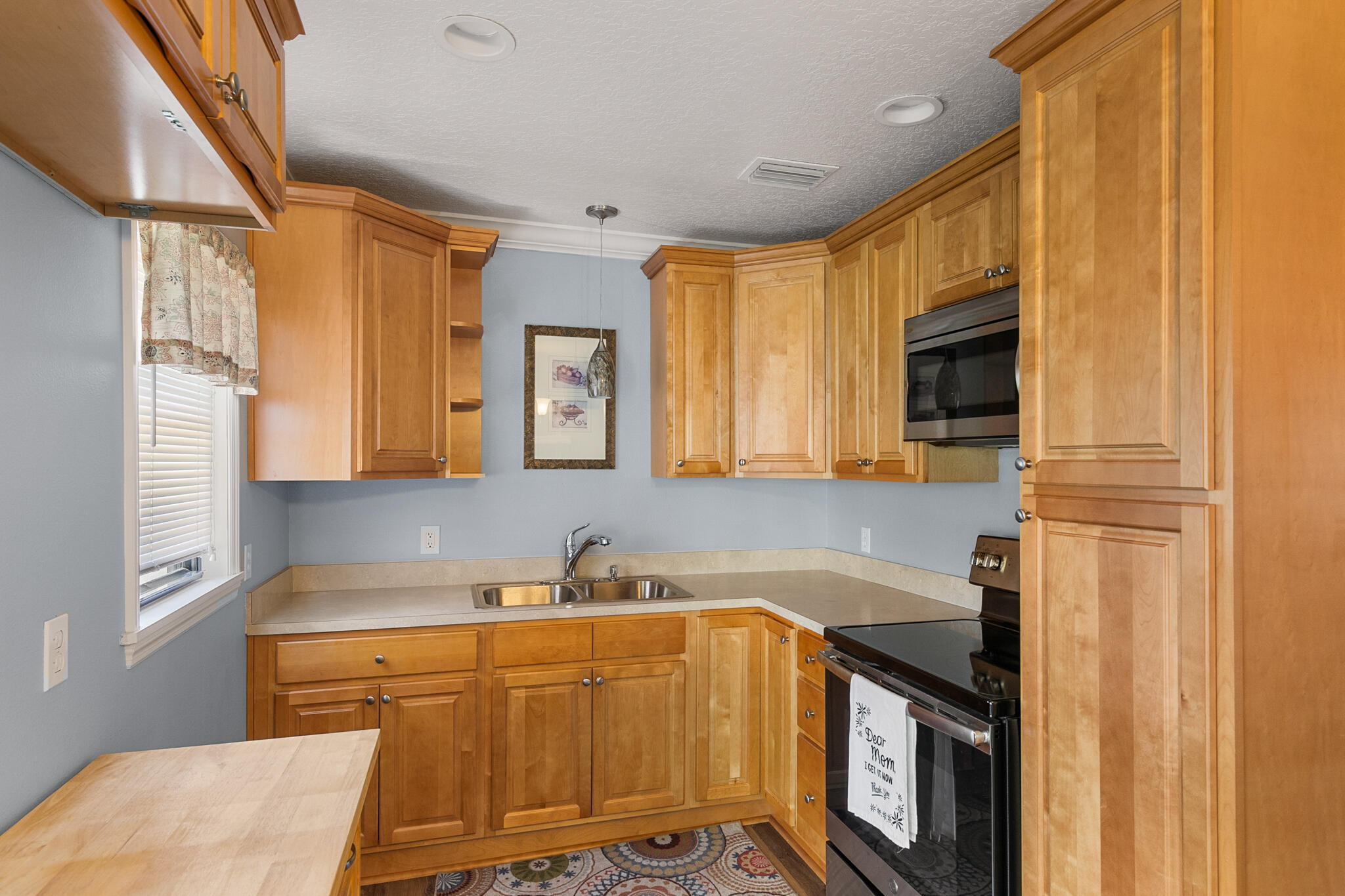 1972 Post Road Melbourne, FL 32935 - Photo 7 of 21 a kitchen with stainless steel appliances granite countertop a sink stove and cabinets