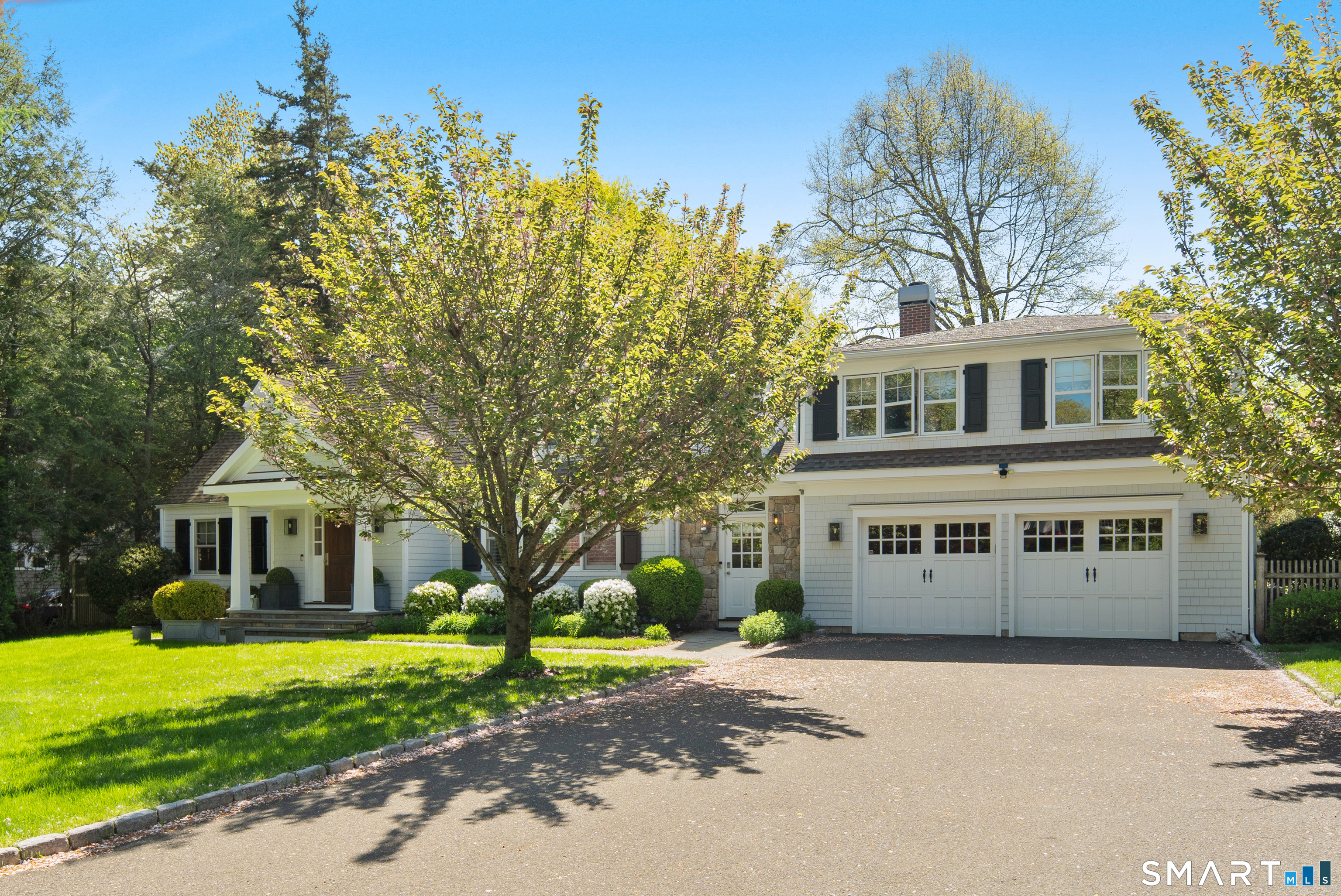 11 McLaren Road South Darien, CT 06820 - Photo 3 of 40 a front view of a house with a yard and garage