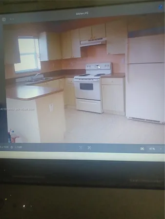a kitchen with a stove and cabinets