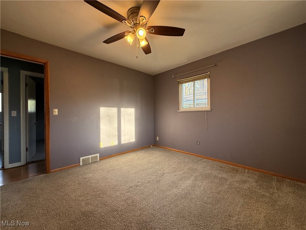 9083 Priem Road Strongsville, OH 44149 - Photo 15 of 28 Carpeted empty room featuring visible vents, baseboards, and ceiling fan