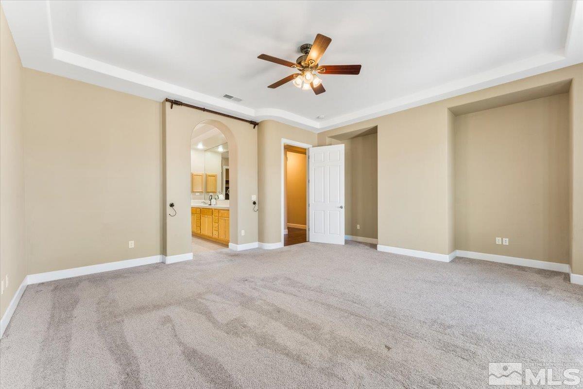 10145 Burghley Lane Reno, NV 89521 - Photo 15 of 31 a view of an empty room with a ceiling fan