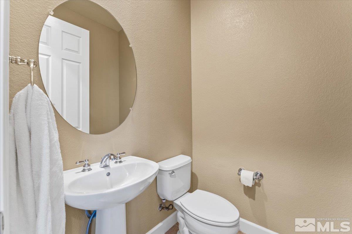 10145 Burghley Lane Reno, NV 89521 - Photo 19 of 31 a bathroom with a sink mirror and toilet