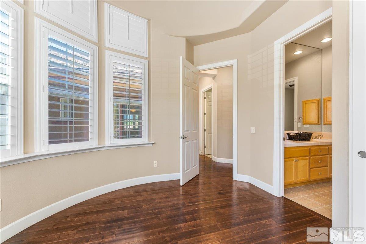 10145 Burghley Lane Reno, NV 89521 - Photo 21 of 31 a view of a hallway with wooden floor and a cabinet