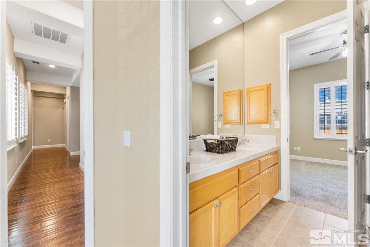 10145 Burghley Lane Reno, NV 89521 - Photo 22 of 31 a en suite bathroom with a sink and mirror