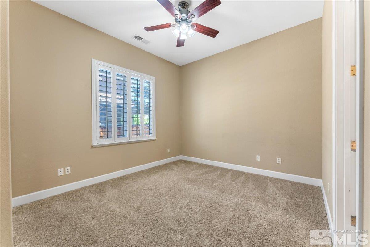 10145 Burghley Lane Reno, NV 89521 - Photo 24 of 31 an empty room with windows and fan