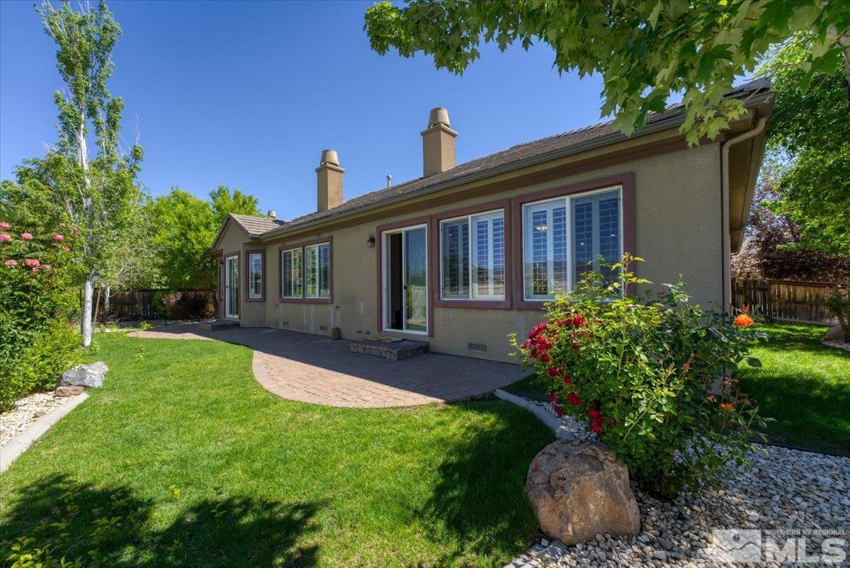 10145 Burghley Lane Reno, NV 89521 - Photo 30 of 31 a view of a house with backyard and sitting area