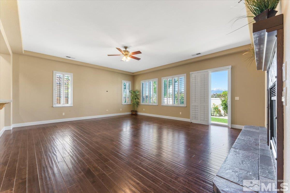 10145 Burghley Lane Reno, NV 89521 - Photo 7 of 31 a view of an empty room with a window and wooden floor