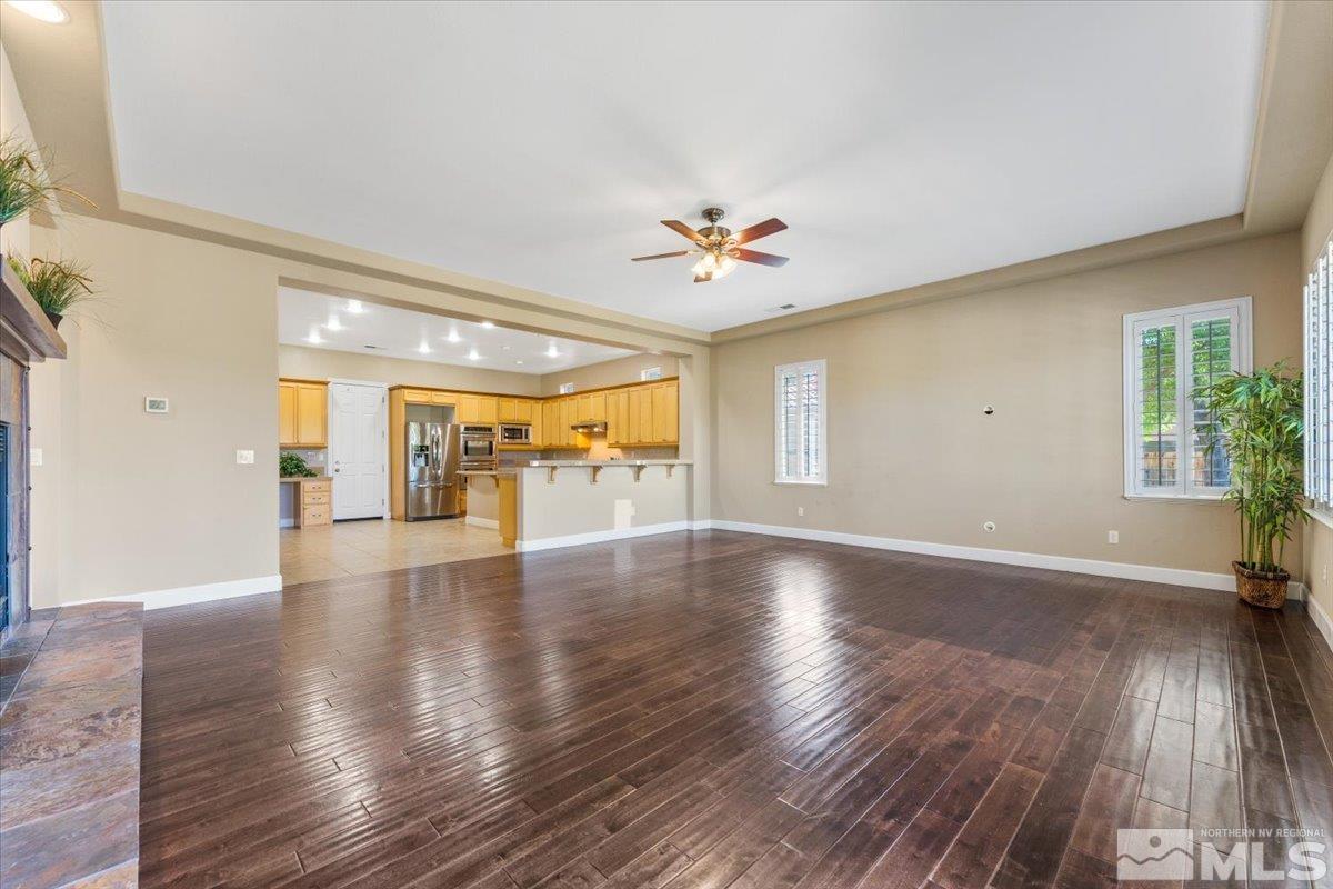 10145 Burghley Lane Reno, NV 89521 - Photo 9 of 31 a view of an empty room with wooden floor and a window