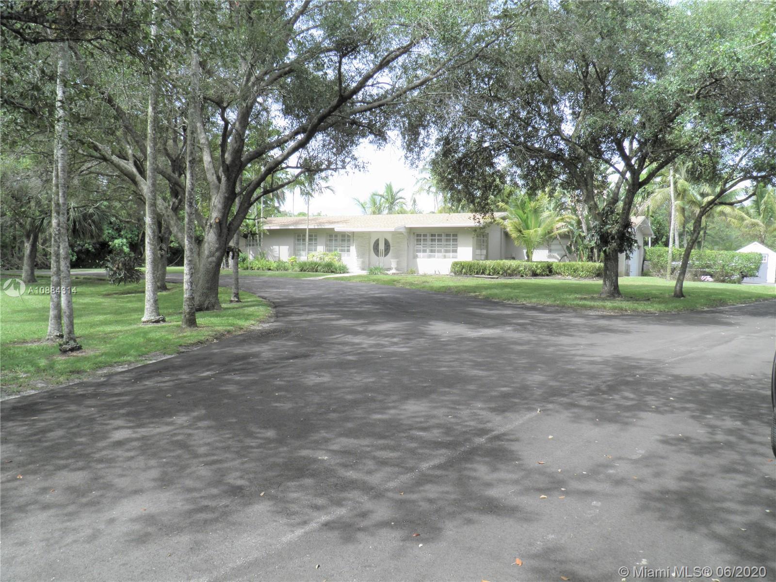 6311 Hancock Road Southwest Ranches, FL 33330 - Photo 1 of 23 a view of a yard in front of a house
