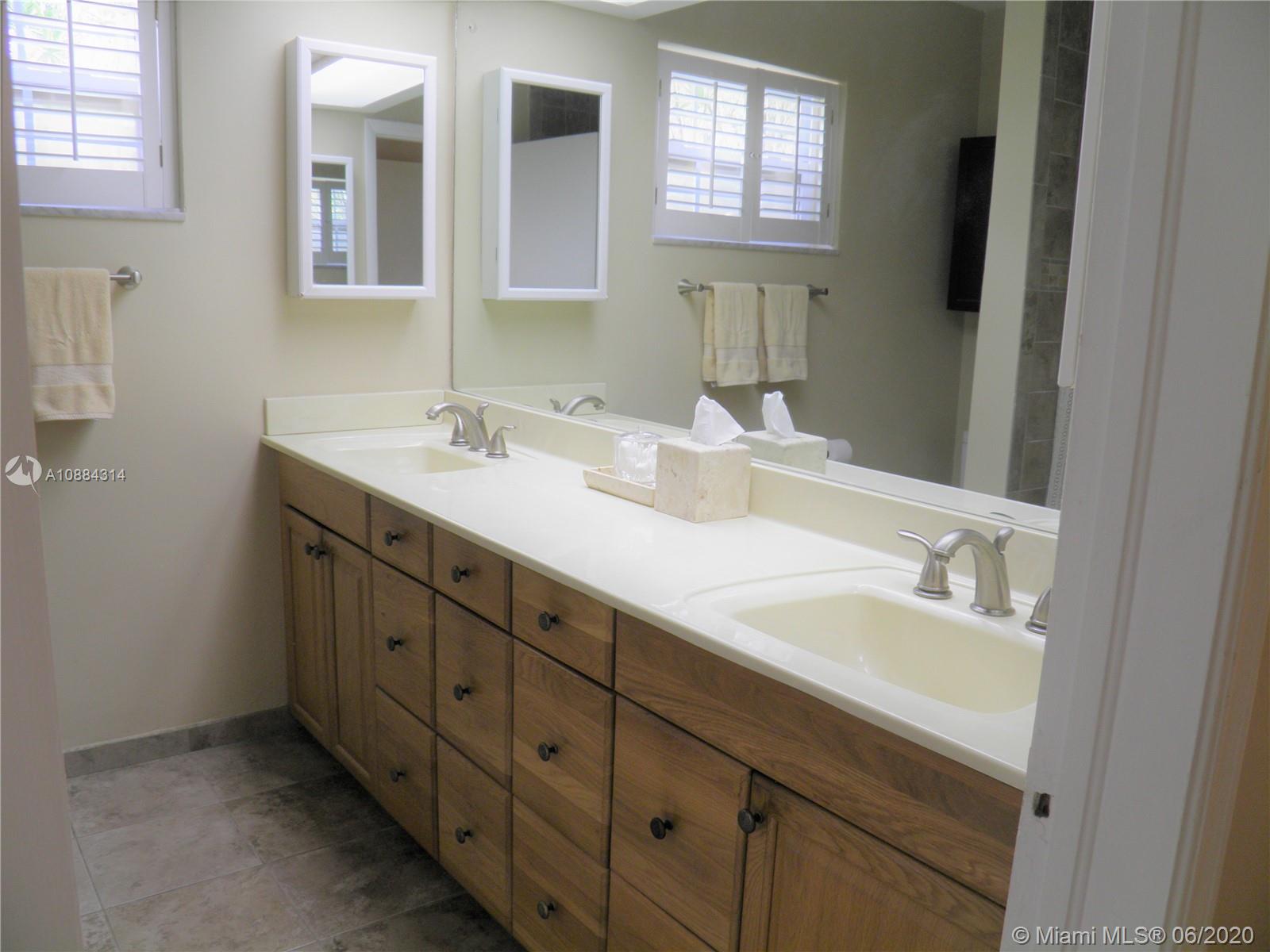6311 Hancock Road Southwest Ranches, FL 33330 - Photo 12 of 23 a bathroom with double sink and a mirror