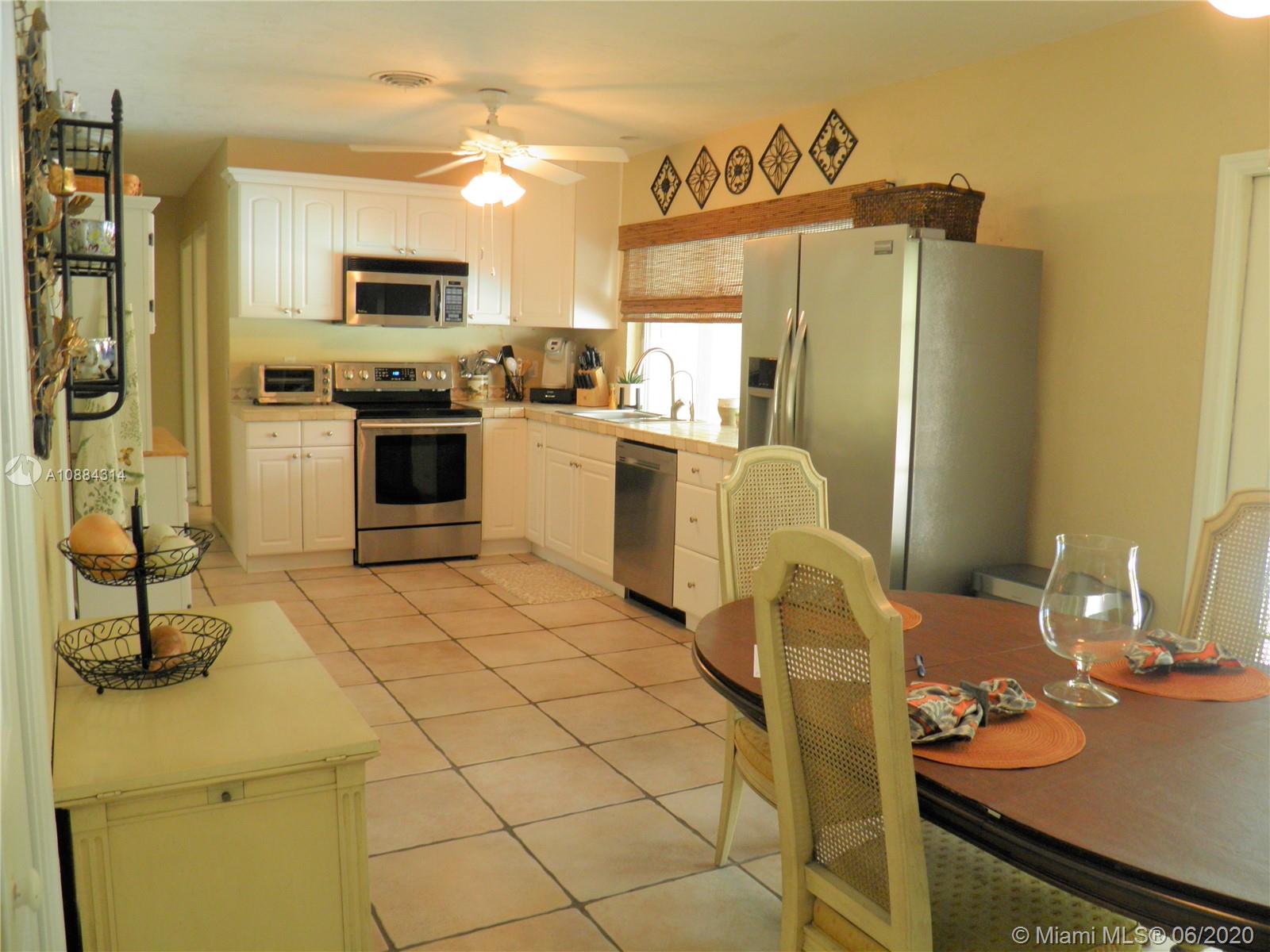 6311 Hancock Road Southwest Ranches, FL 33330 - Photo 17 of 23 a kitchen with stainless steel appliances a stove a sink and white cabinets