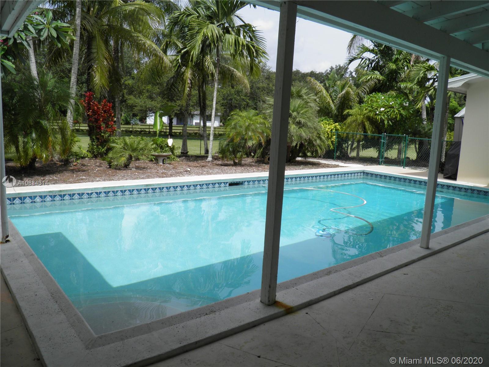 6311 Hancock Road Southwest Ranches, FL 33330 - Photo 19 of 23 a view of a swimming pool with a yard