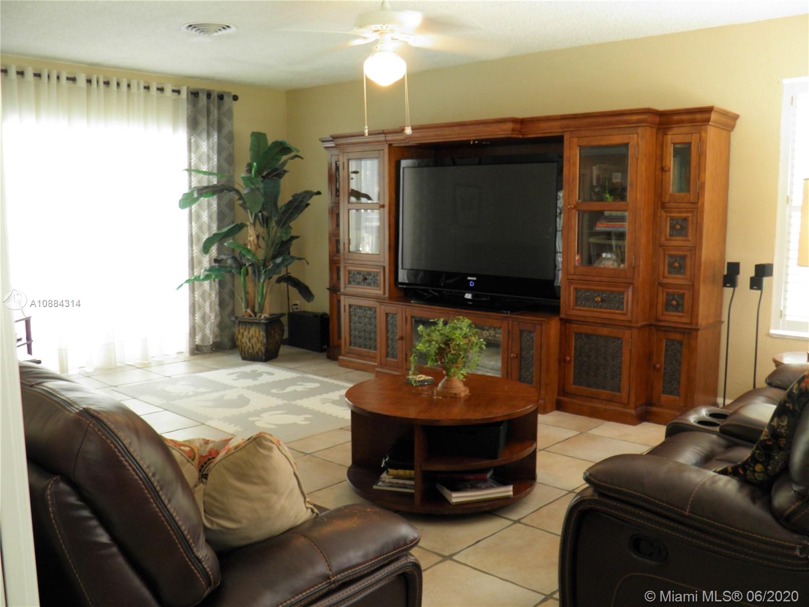 6311 Hancock Road Southwest Ranches, FL 33330 - Photo 9 of 23 a living room with furniture and a flat screen tv