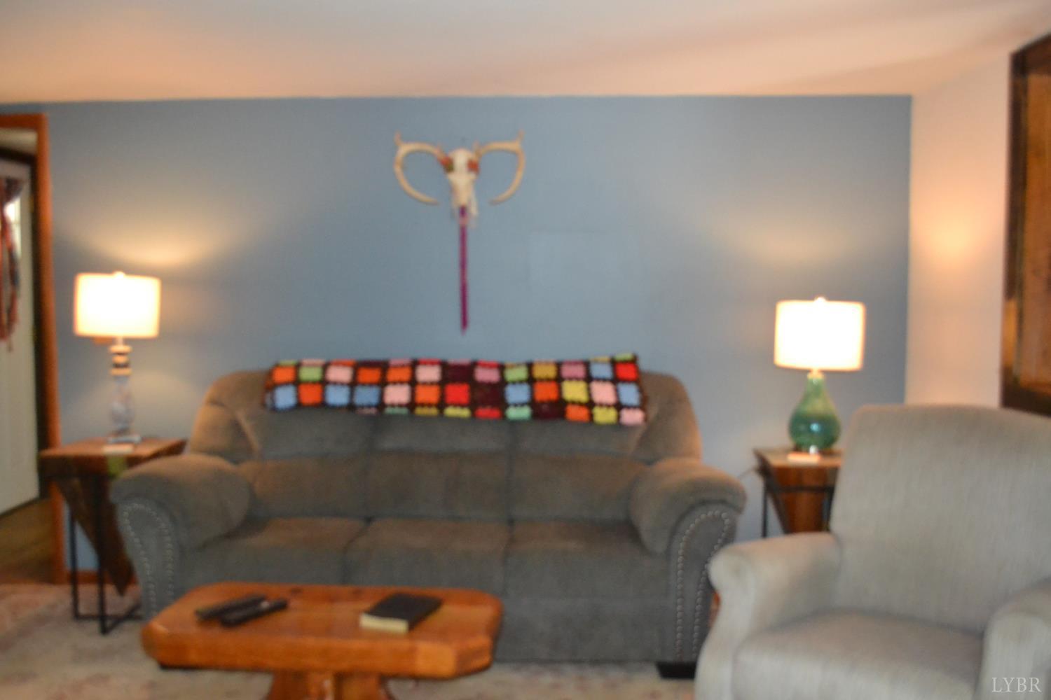 6387 Red House Road Rustburg, VA 24588 - Photo 16 of 38 a living room with furniture and a wooden floor