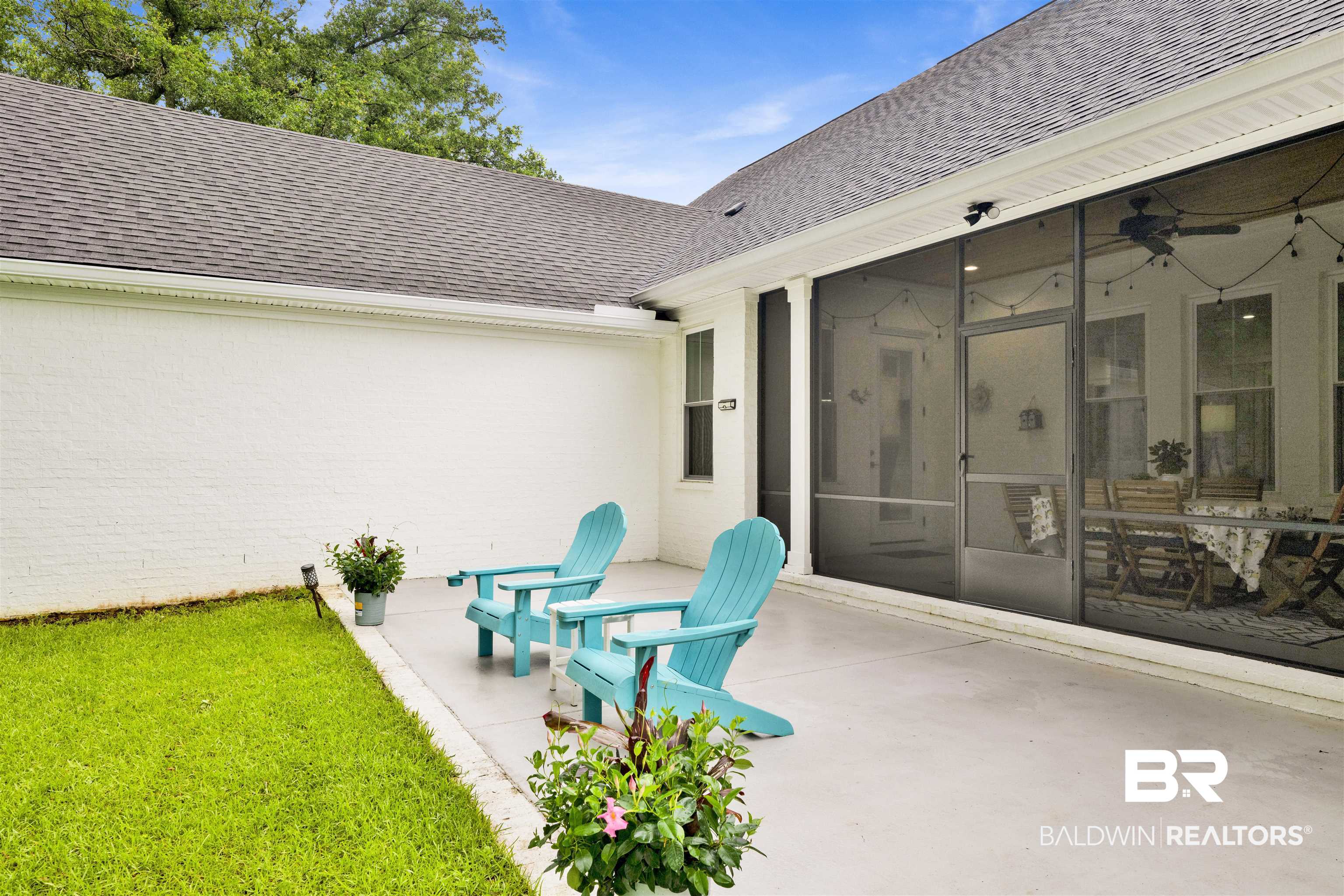 21702 Pillars Street Fairhope, AL 36532 - Photo 38 of 54 Spacious screened patio featuring a ceiling fan, string lighting, and direct access to a private lawn area