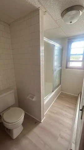 a bathroom with a toilet and a shower