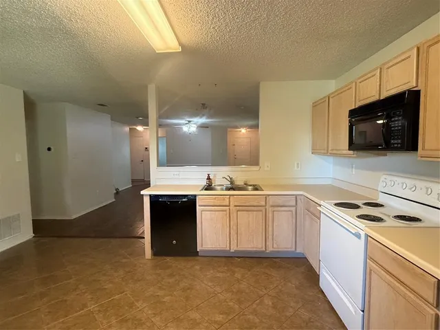a kitchen with a sink stove and microwave
