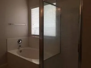 a bathroom with a granite countertop sink toilet and bathtub
