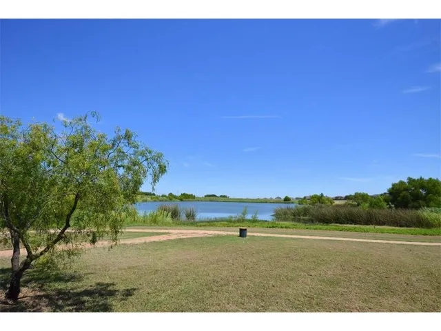 an aerial view of residential building and lake