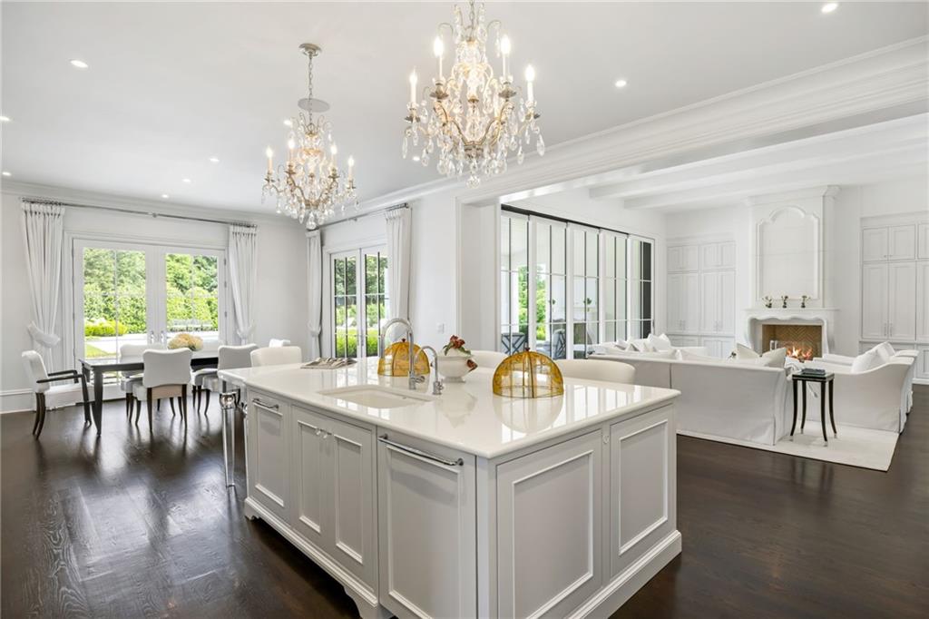1640 Kenai Road Marietta, GA 30064 - Photo 2 of 43 a very nice looking dining room with kitchen island a large window a couch and a chandelier
