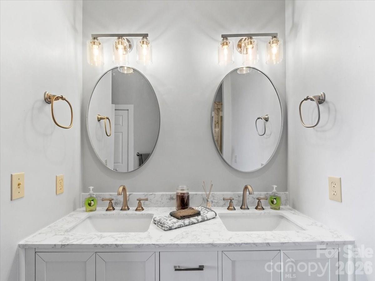 140 Slickrock Road, Unit F4 Burnsville, NC 28714 - Photo 23 of 41 a bathroom with a granite countertop double vanity sinks and a mirror