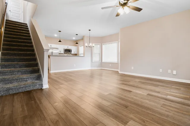 a view of kitchen and hall with wooden floor