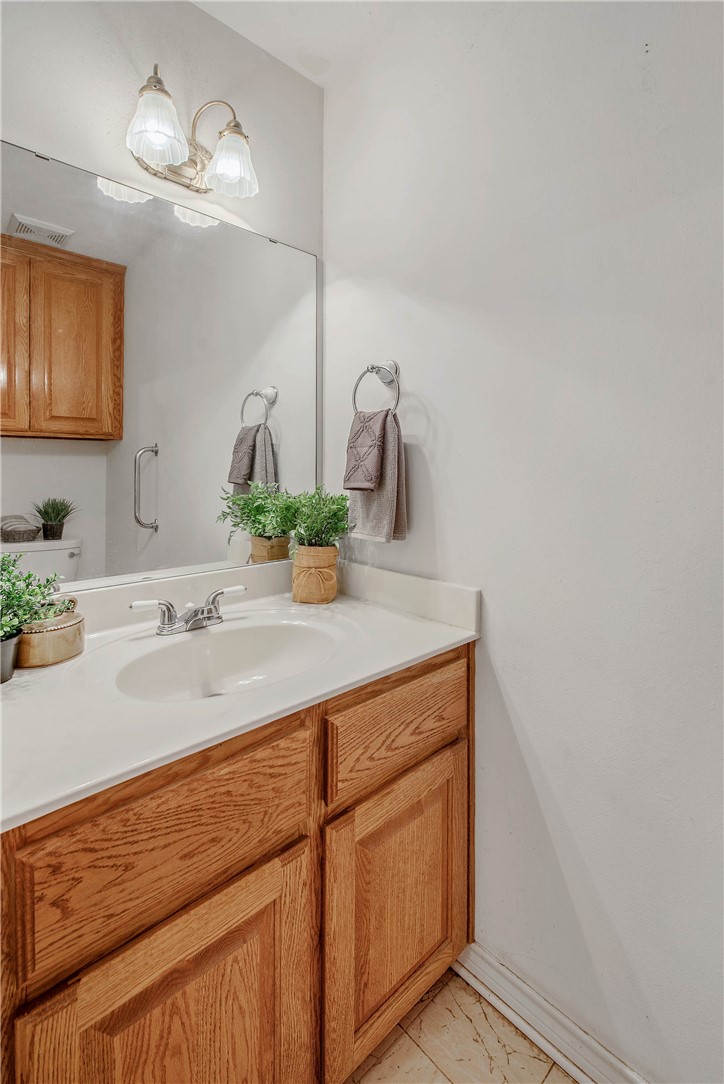 1110 County Road 439 Dime Box, TX 77853 - Photo 35 of 50 a bathroom with a sink and a mirror
