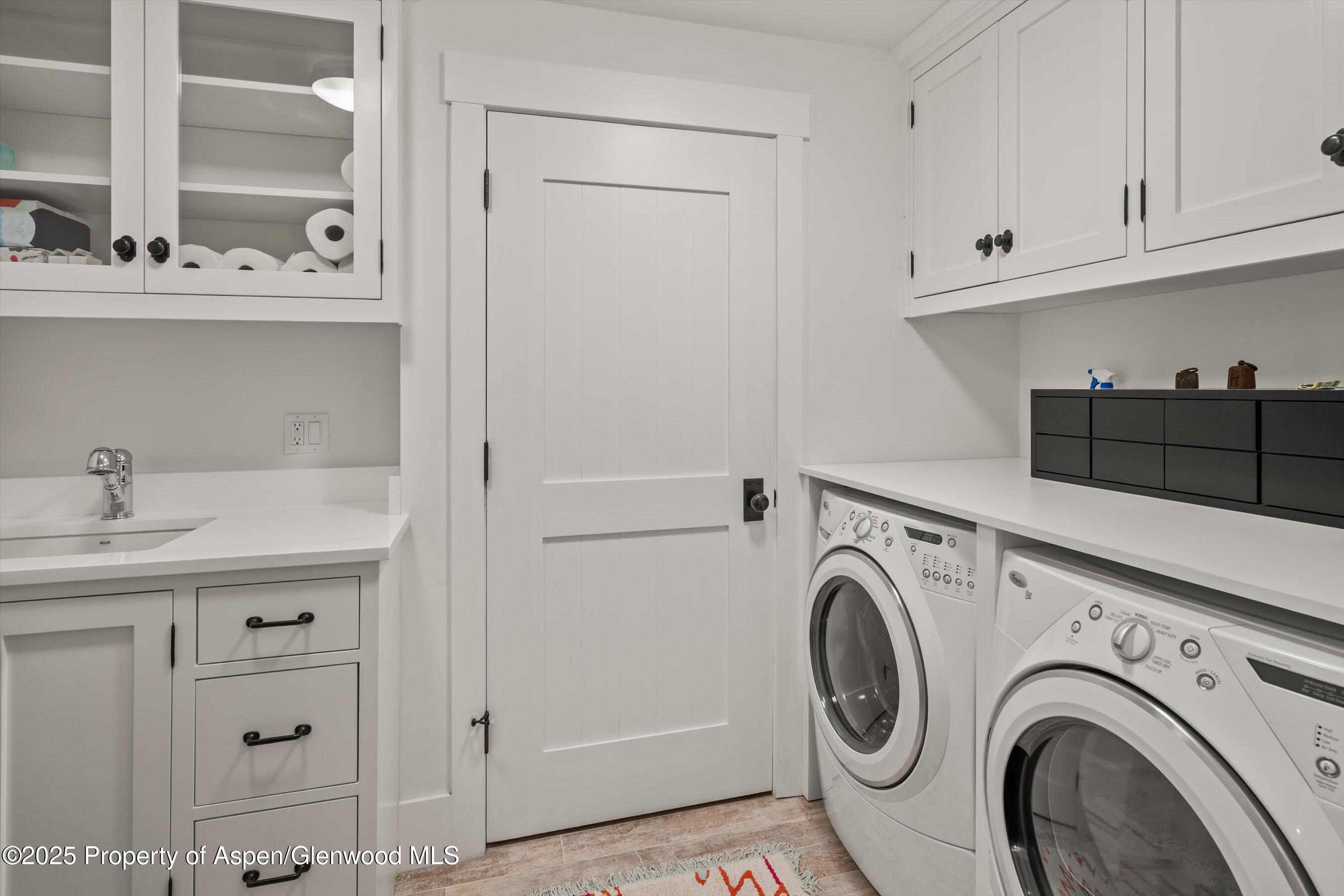 9555 Castle Creek Road Aspen, CO 81612 - Photo 28 of 42 a view of storage and utility room with washer and dryer