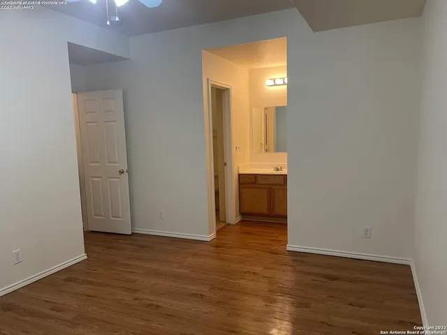 a view of a room with wooden floor and cabinet