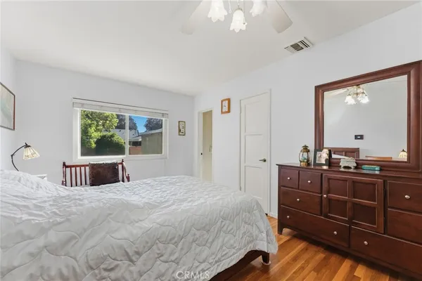a bedroom with a bed and a dresser
