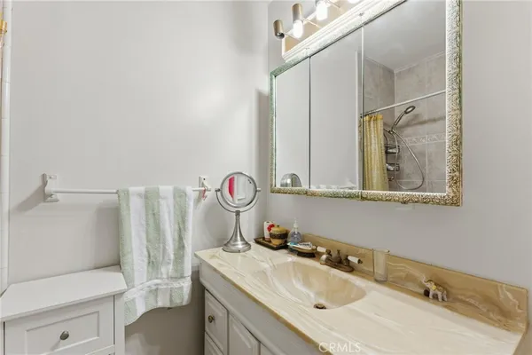 a bathroom with a sink vanity mirror and toilet