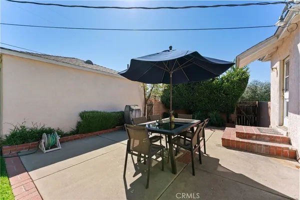 a patio with a patio table and chairs