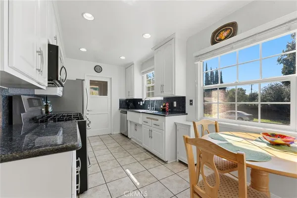a kitchen with a sink cabinets and window