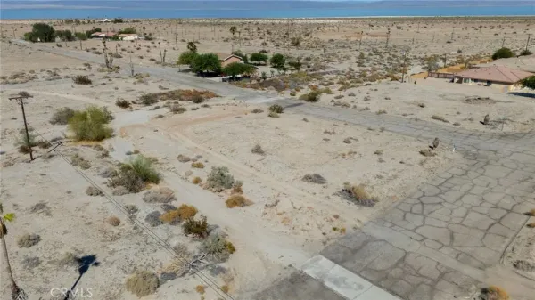 a view of a beach with a stone wall