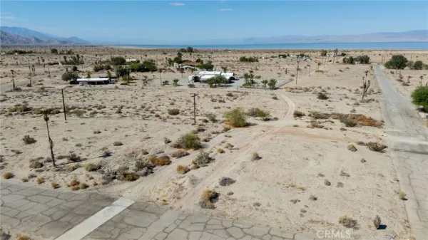 a view of water covered with snow on the beach