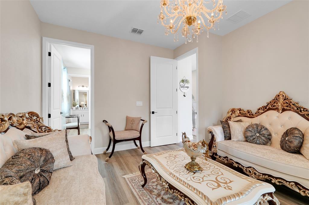 10169 Spring Lake Drive Clermont, FL 34711 - Photo 11 of 54 a bedroom with furniture and a chandelier