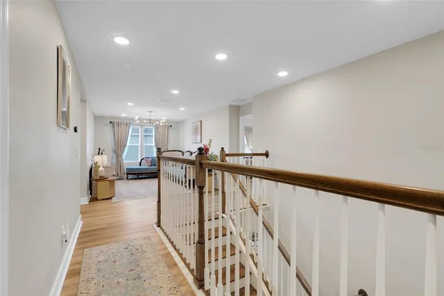 a bed room with a bed mirror and a chandelier