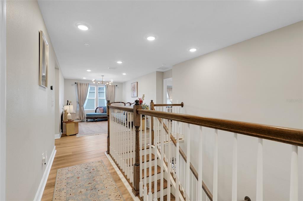 10169 Spring Lake Drive Clermont, FL 34711 - Photo 17 of 54 a view of a hallway with wooden floor and stairs