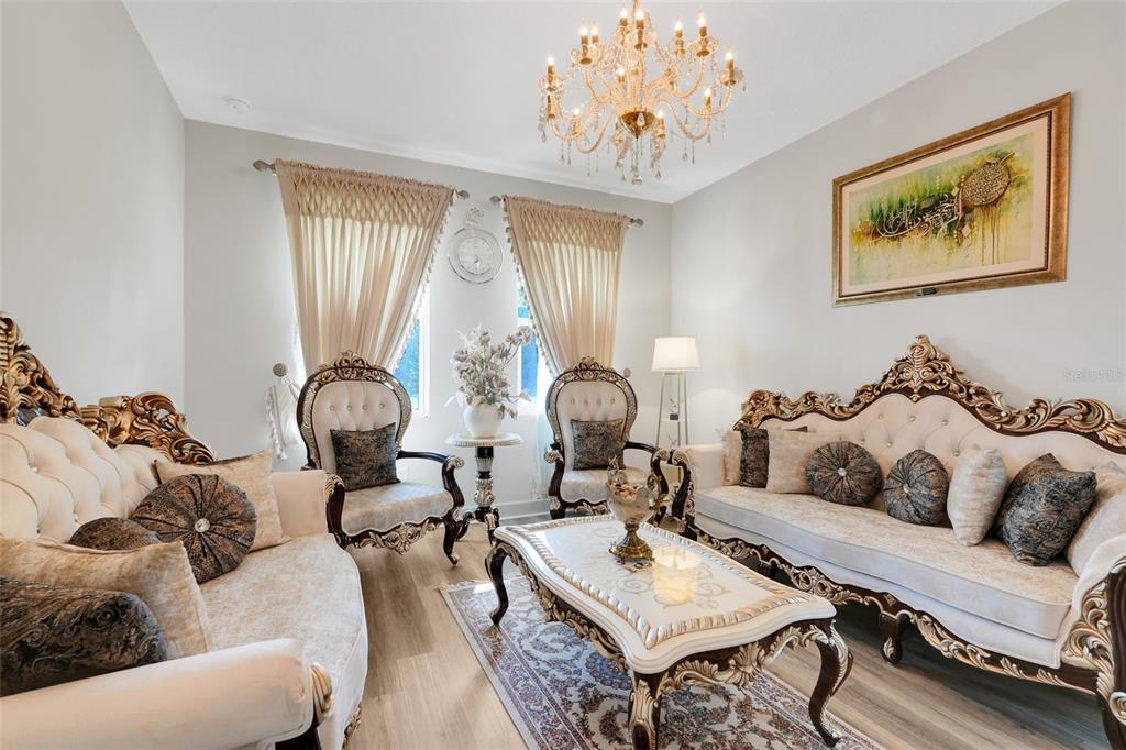 10169 Spring Lake Drive Clermont, FL 34711 - Photo 2 of 54 a living room with furniture chandelier and a window