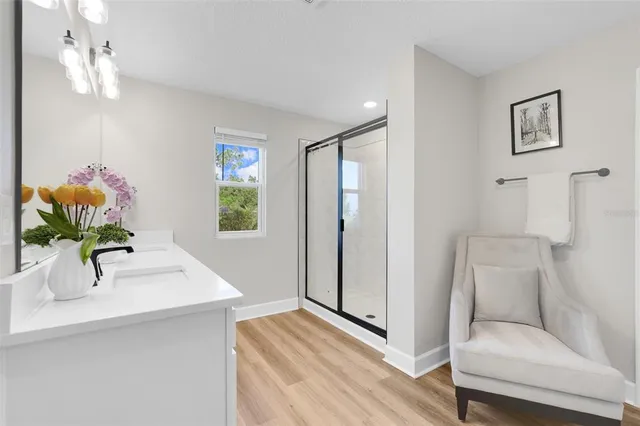 an aerial view of residential houses with outdoor space and trees