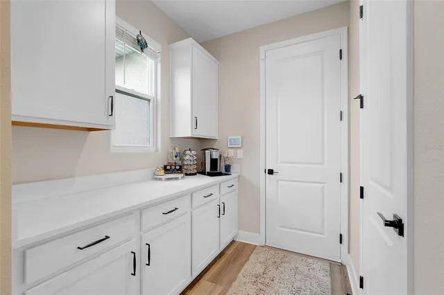 a view of a patio with table and chairs with wooden fence