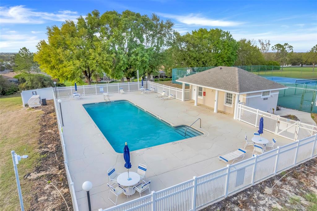 10169 Spring Lake Drive Clermont, FL 34711 - Photo 47 of 54 a view of a patio with table and chairs with wooden fence