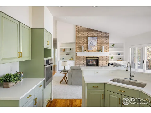 a kitchen with kitchen island a stove a sink and a refrigerator