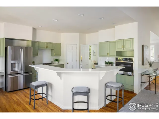 a kitchen with stainless steel appliances a refrigerator and a stove top oven