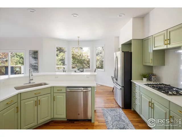 a kitchen with stainless steel appliances a refrigerator sink and stove