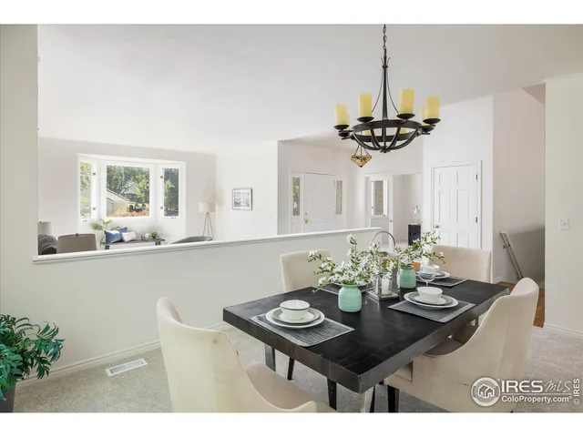 a view of a dining room with furniture and a chandelier