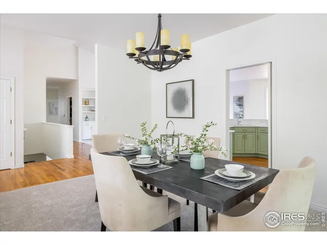 a view of a dining room with furniture and chandelier